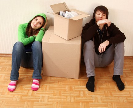 Local movers carrying household items down stairs in a period property